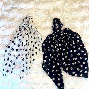 Two white and black hair scrunchie bows.